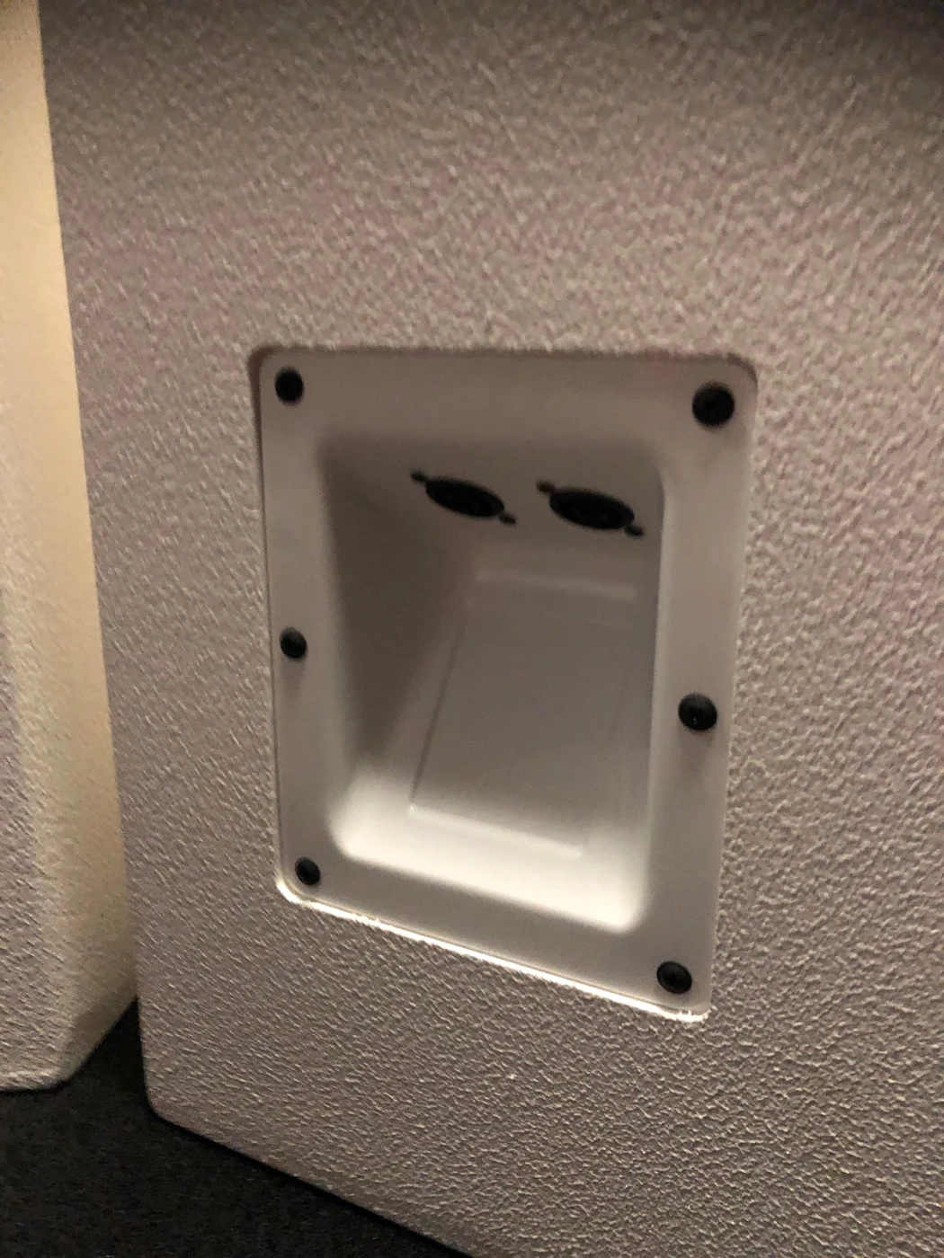 Recessed connections on the custom white cabinet
